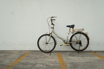 Old rusty vintage bicycle at bicycle parking. Eco friendly and urban lifestyle concept.