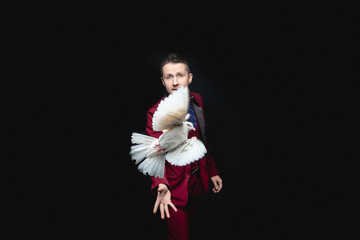 Magician man shows trick with trained white dove bird