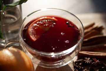 mulled wine on a wooden tray with orange and spices. Mulled wine ingredients. Winter cocktail. drink in a double bottom cup.