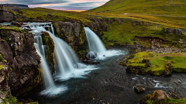 VIDEO LOOP SEAMLESS: Iceland timelapse photography of famous waterfall and mountain. Kirkjufellsfoss and Kirkjufell in northern Iceland nature landscape. Time lapse video in 4K - looping video.
