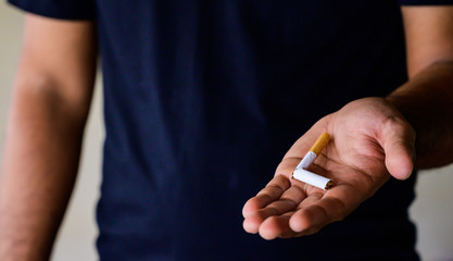 Male hand crushing cigarette. Stop smoking concept