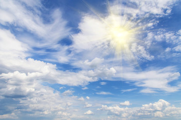 Blue sky with white clouds and sun, sunlight, yellow sun rays