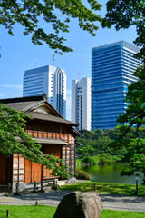 Traditional tea house with city skyline in background, Hamarikyu Gardens, Chuo City, Tokyo, Honshu, Japan