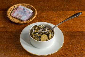 The rise in price of food. Coins instead of soup in a plate. Banknotes instead of bread.