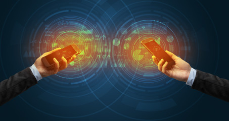 Close up of two smartphones syncing business data