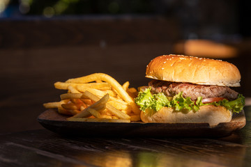tasty hamburger and fried potatoes