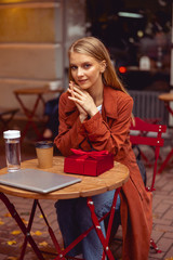 Girl in a street cafe looking forward