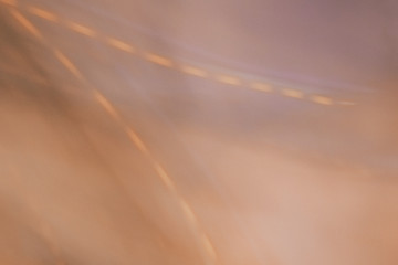 Blurred background of orange and purple fabric with a Christmas garland. Christmas background.