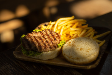 tasty hamburger and fried potatoes
