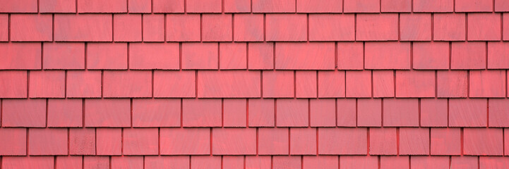 Background of old red wooden shingles. Texture wooden roof