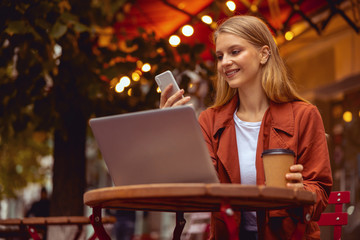 Modern young female reading news on her phone