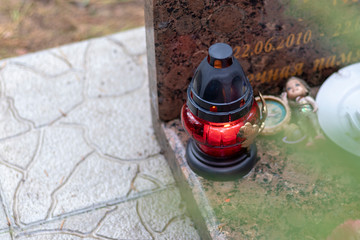 it's raining. the candle is burning. background grave. marble slab.