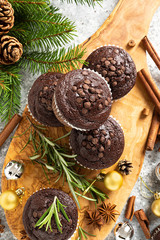Christmas chocolate muffins. Xmas or New Year festive baking with decorations and fir tree
