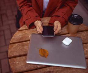 Fototapeta na wymiar Caucasian girl using her electronic devices outdoors