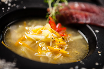 Clear Fish soup served in a bowl in restaurant