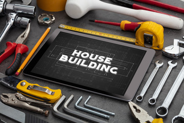 Tablet and tools with home under construction concept