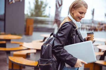 Smiling pretty woman with headphones looking down