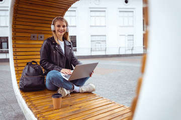 Pretty woman sitting on a solar bench