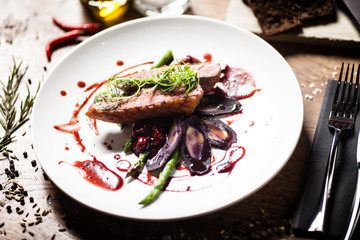Duck breast served on a plate in restaurant