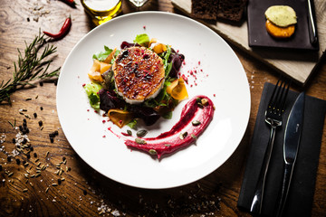 Grilled goat cheese salad served on a plate in restaurant