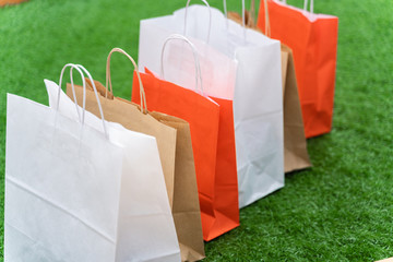 Shopping bags are on the green lawn. Discount concept