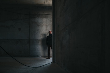 man standing inside an empty concrete building