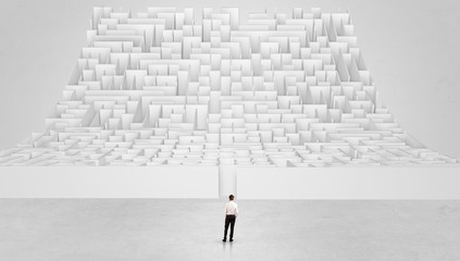 Businessman standing and thinking in front of a curved infinity maze