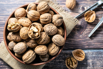 walnuts and nutcracker on rustic wooden table close up.