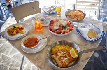 A summer  dinner .Unidentified people eating traditional delicious mediterranean dish  outdoor restaurant  in Cyprus , Ayia-napa.Tasty and authentic cypriot kitchen