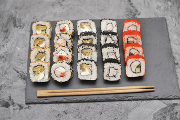 Japanese rolls on stone background.