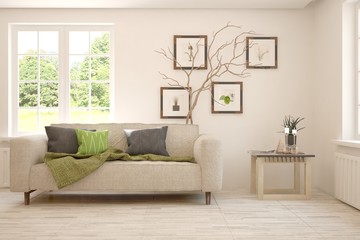 Stylish room in white color with sofa and summer landscape in window. Scandinavian interior design. 3D illustration