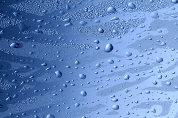 Close-up of fingerprints on wet glass with drops