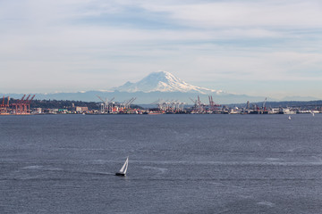 Downtown Seattle, Washington, United States of America. Aerial View of a Sail Boat with Mt Rainier in the background.