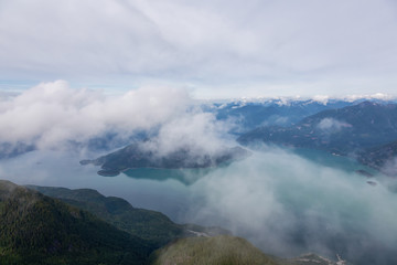 Aerial Landscape View of the Howe Sound during a cloudy summer morning. Taken North of Vancouver, British Columbia, Canada.