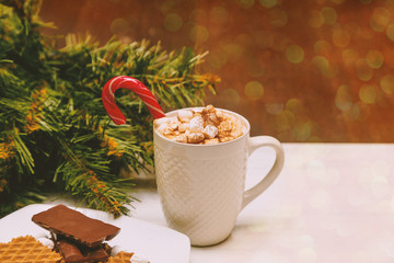 Winter whipped cream hot coffee in a red mug with marshmallow. christmas postcard
