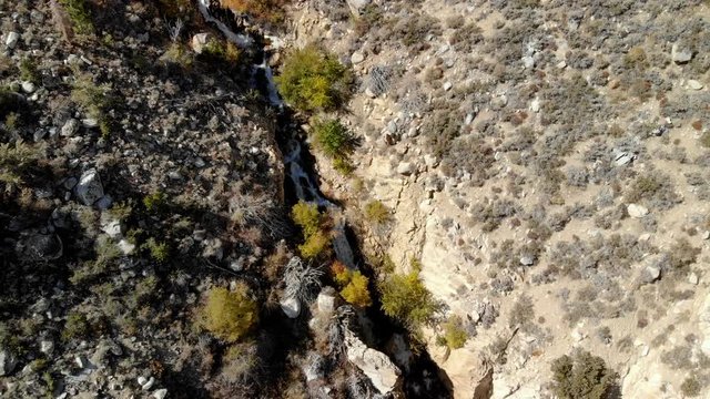 Aerial Shot of Runoffs thru Rugged Canyon in Sierra Nevada -Look Down-