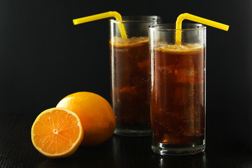 Glasses with cuba libre cocktail or cola with ice or cold tea with lemon