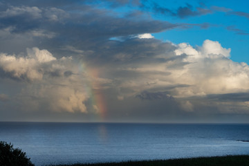 Beautiful storm clouds with rainbow in Whitsand bay Looe Cornwall 