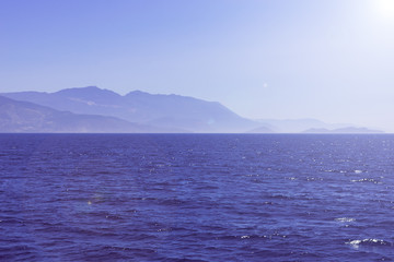 Summer seascape with mountains and blue sea water