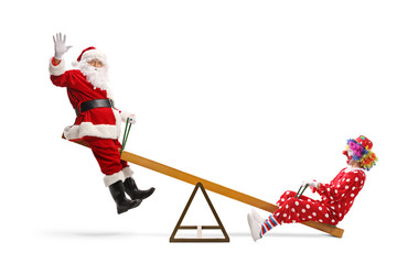 Santa waving and playing on a seesaw with a clown