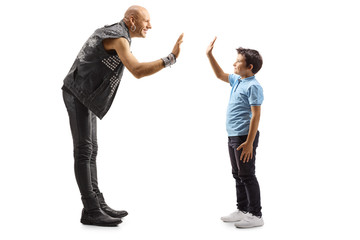 Punk gesturing high-five with a little boy