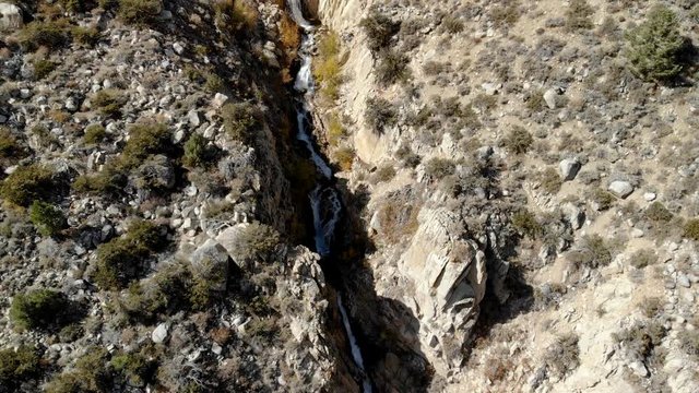 Aerial Shot of Runoffs thru Rugged Canyon in Sierra Nevada -Reveal-