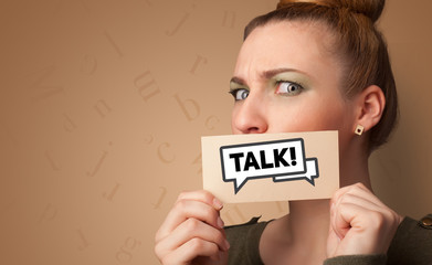 Person holding card in front of his mouth, friendship concept