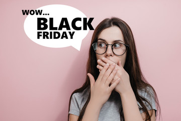 Stunned crazy woman stares with scared expression, covers mouth with both hands, poses against pink background. Concept of sales, black friday, cyber monday, finance. Online shops and payments bill