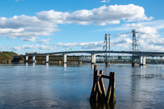 View of bridge over Kennebec river in Bath, Maine On A Sunny Afternoon with light clouds in sky.
