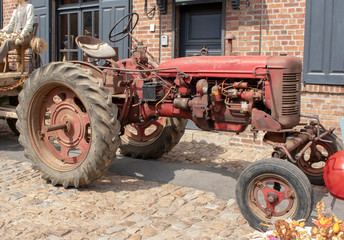 Old fashioned tractor in the village of Arleux