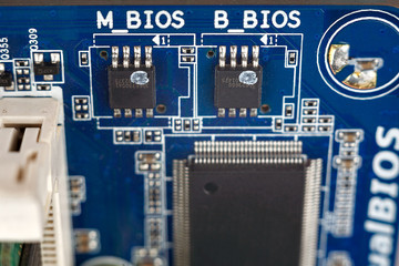 BIOS chips close-up macro on the motherboard of the computer, the firmware of the electronic device...