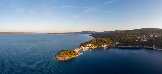 Spectacular aerial landscape with fishing village near peninsula stretching into the sea.