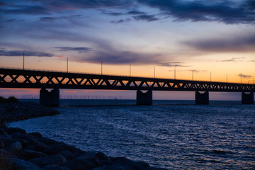 Öresund bridge with wind wheels and sundown 