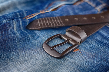 men's leather trouser belt in the background of denim, men's closet, jeans